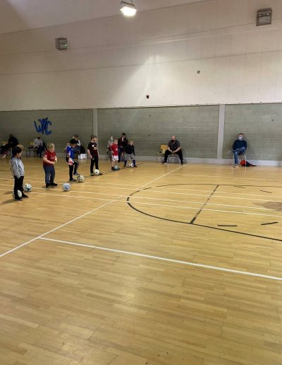 Kids play football in indoor pitch