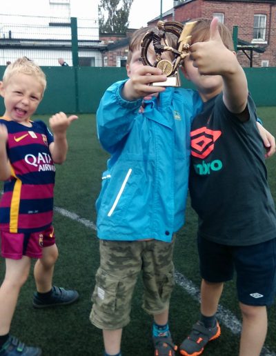 Kids and Football Trophies